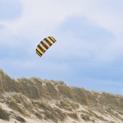 Tie Dye 62\" Sport Air Foil kite soaring in the sky, showcasing bright colors and intricate patterns against a clear blue background.