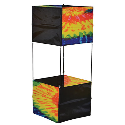 Tie Dye Box Kite flying high against a blue sky, showcasing its vibrant tie-dye design and sturdy fiberglass structure.