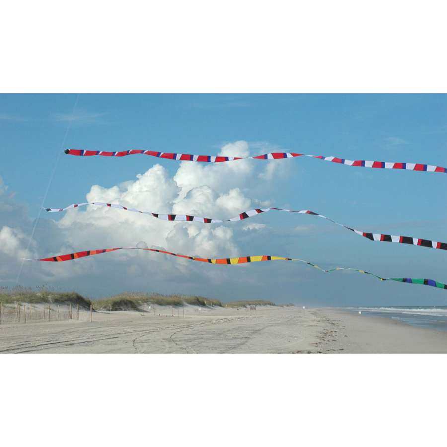 3 in. x 25 ft. Rainbow Transition Tail beautifully displayed behind a flying kite, showcasing vibrant colors against a clear sky.