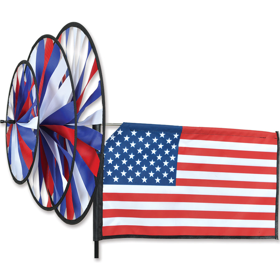 Triple Spinner - American Flag garden ornament featuring a vibrant design made from fade-resistant SunTexTM fabric spinning in a yard setting.