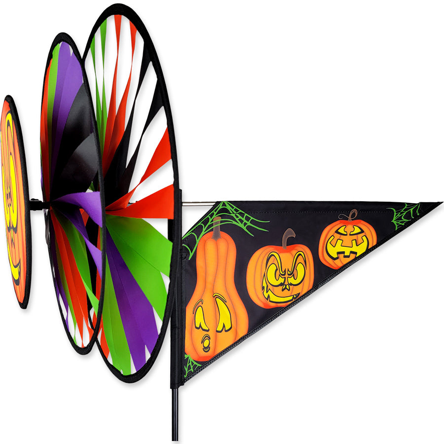 Triple Spinner - Jack O'Lanterns featuring colorful pumpkin faces on counter-rotating wheels, displayed outdoors in a festive Halloween setting.