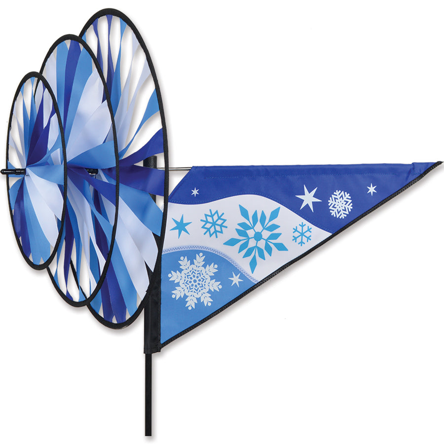 Triple Spinner - Snowflake with vibrant colors and intricate designs spinning gracefully in the wind in an outdoor setting.