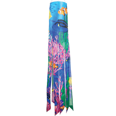 Tropical Fish 40\" Illusion Windsock displaying a vivid fish design and colorful tails, fluttering in a gentle breeze in a garden setting.