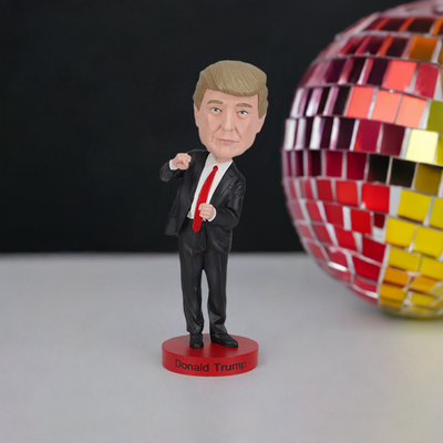 Trump Dance Bobblehead displaying Donald Trump in a suit with a playful dance pose, highlighting vibrant details for political humor lovers.