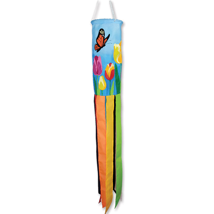 Vibrant tulips windsock featuring embroidered flowers, a butterfly, and a bee, displayed outdoors swaying gently in the breeze.