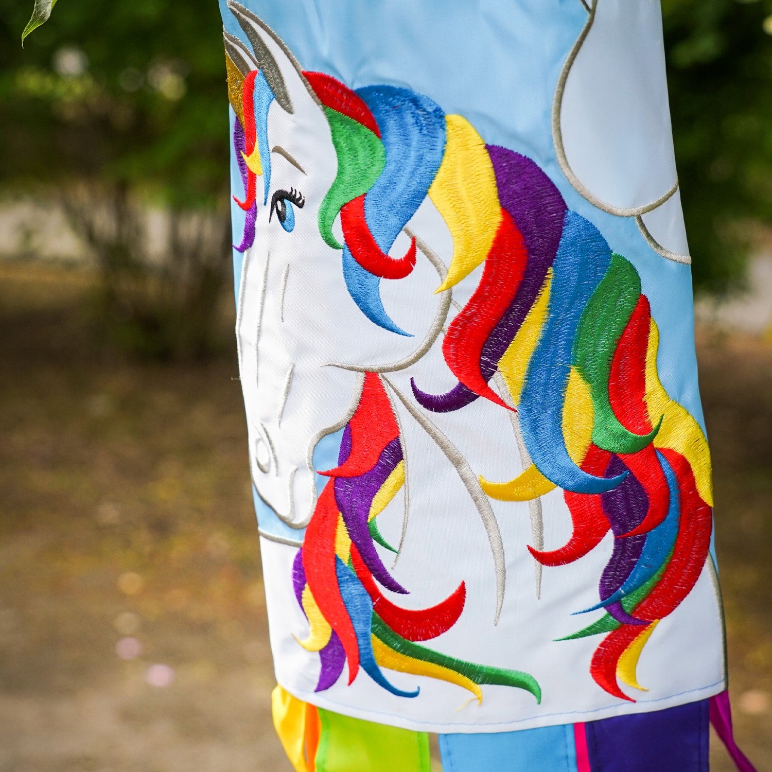 Unicorn 40-inch windsock in vibrant colors with a whimsical design features embroidered details, fluttering tails, and durable material for outdoor enjoyment.