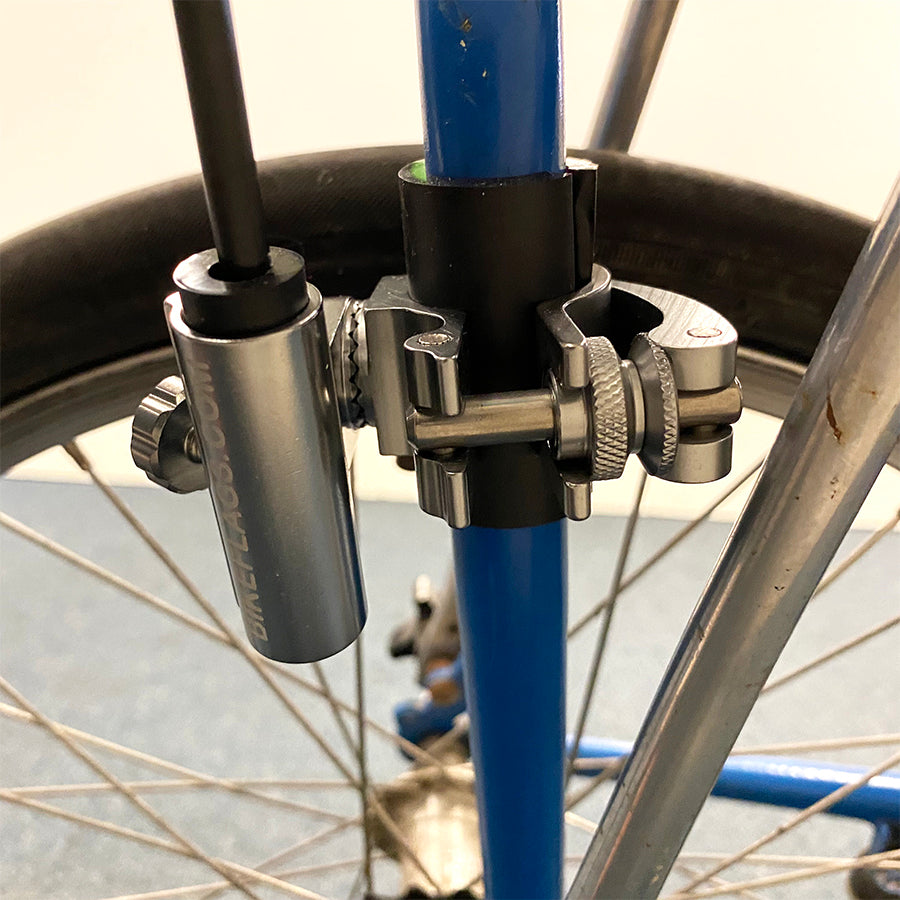 Universal Bike Flag Mount securely attached to a bike frame, holding a colorful flag, perfect for enhancing visibility while cycling.