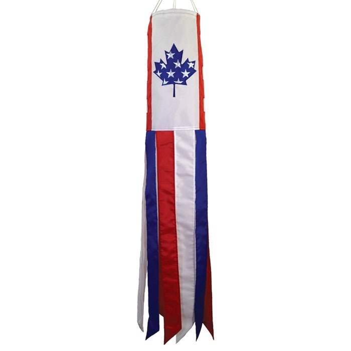 US/Canada Friendship 40' windsock displaying vibrant colors and embroidered graphics, fluttering in the breeze in an outdoor setting.