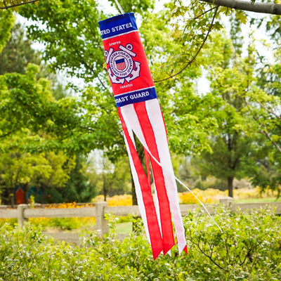 U.S. Coast Guard 40 inch windsock with detailed appliqued graphics and embroidered accents, fluttering outdoors in a garden setting.