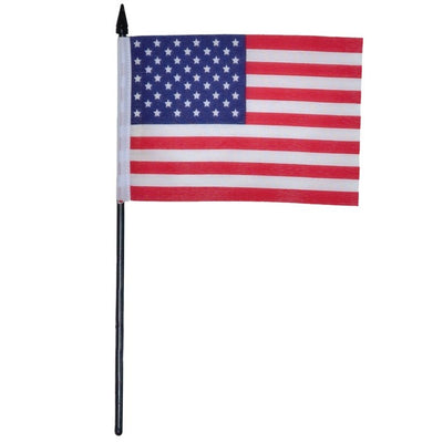 U.S. Flag 4x6 Stick Flag with vibrant stars and stripes on a black stick, ideal for holiday celebrations and outdoor decor displayed at a gathering.