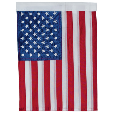 US Flag Embroidered Garden Flag with embroidered stars displayed on a flagpole in a vibrant garden setting.