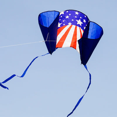 30-inch USA Sled Kite with vibrant Stars and Stripes design soaring against a blue sky, showcasing its easy-flying characteristics and stability.
