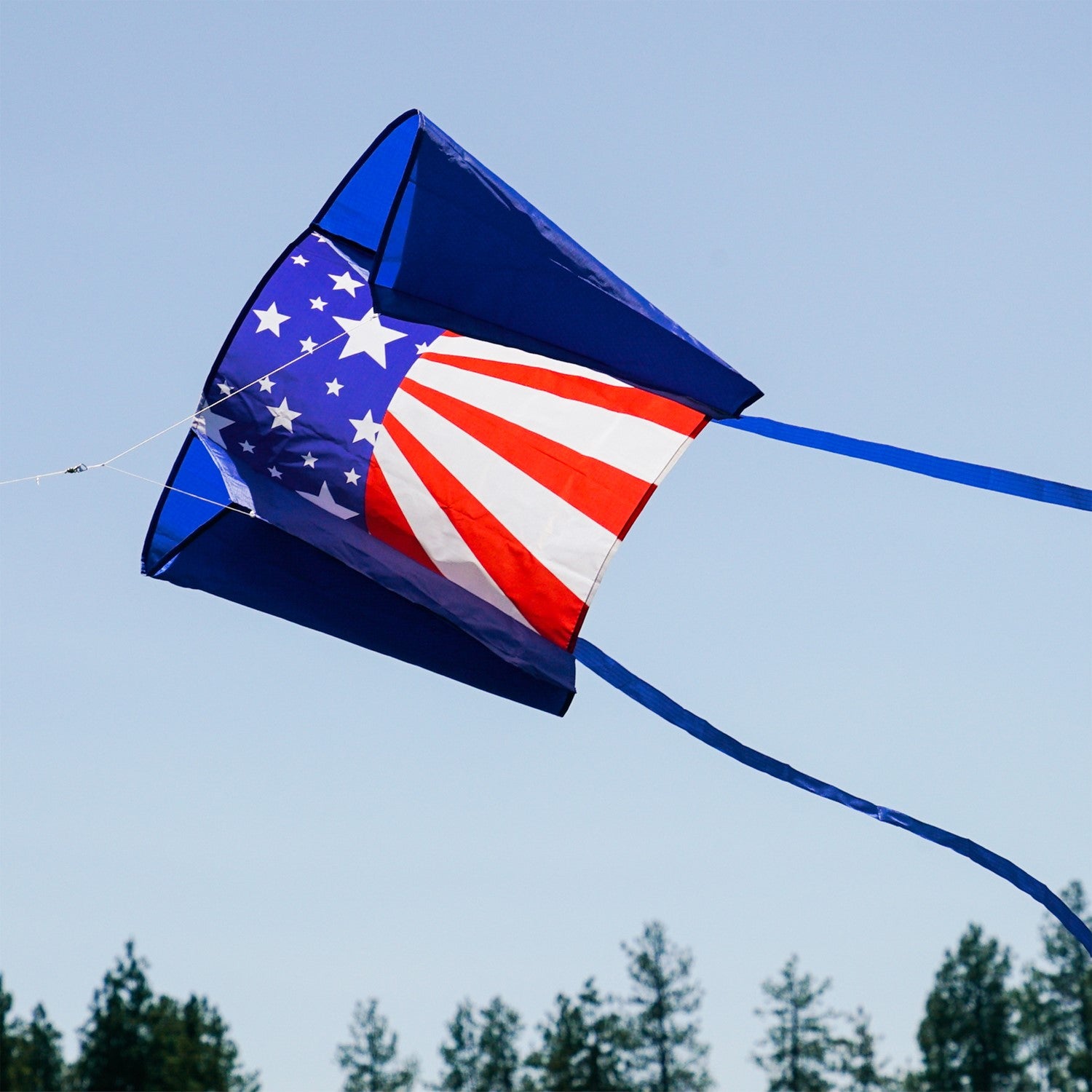 30-inch USA Sled Kite with vibrant Stars and Stripes design soaring against a blue sky, showcasing its easy-flying characteristics and stability.