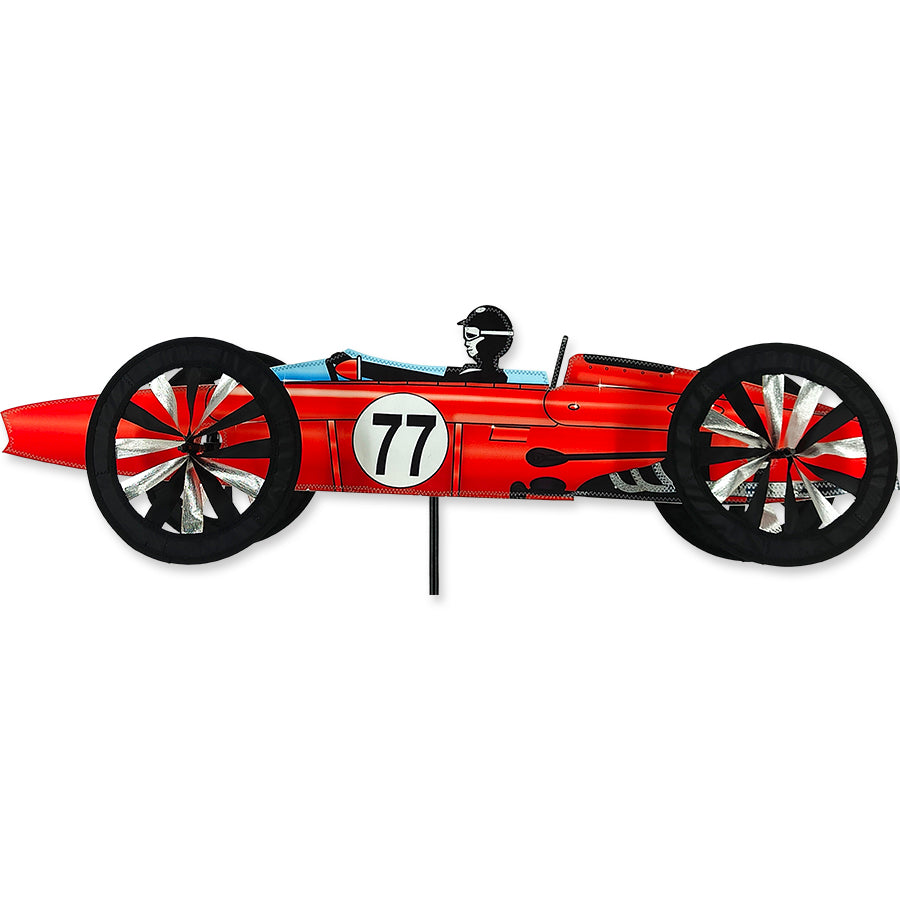 Vintage red race car model with intricate details, displayed against a neutral background showcasing its vibrant color and craftsmanship.