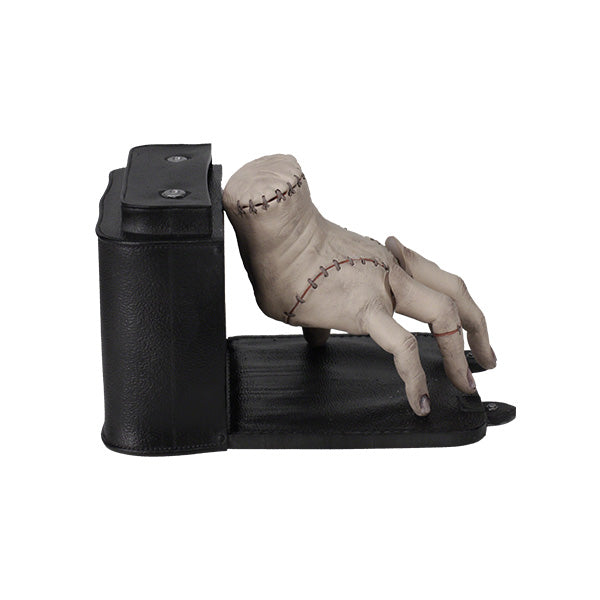 Wednesday Thing Bobblefingers bobblehead featuring a detailed design of Wednesday Adams and Thing, displayed on a shelf among collectibles.