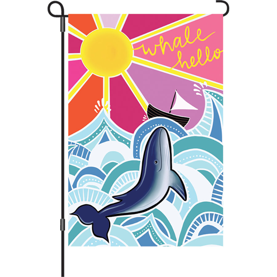12-inch Whale Hello garden flag made from soft PremierSoft fabric, featuring playful underwater design, displayed outdoors in a garden setting.