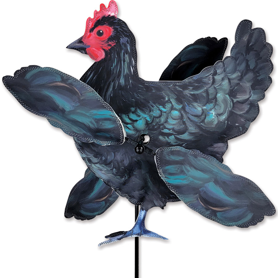 WhirliGig Spinner - Black Hen in vibrant SunTex fabric spinning lightly in a garden setting, creating a joyful outdoor atmosphere.