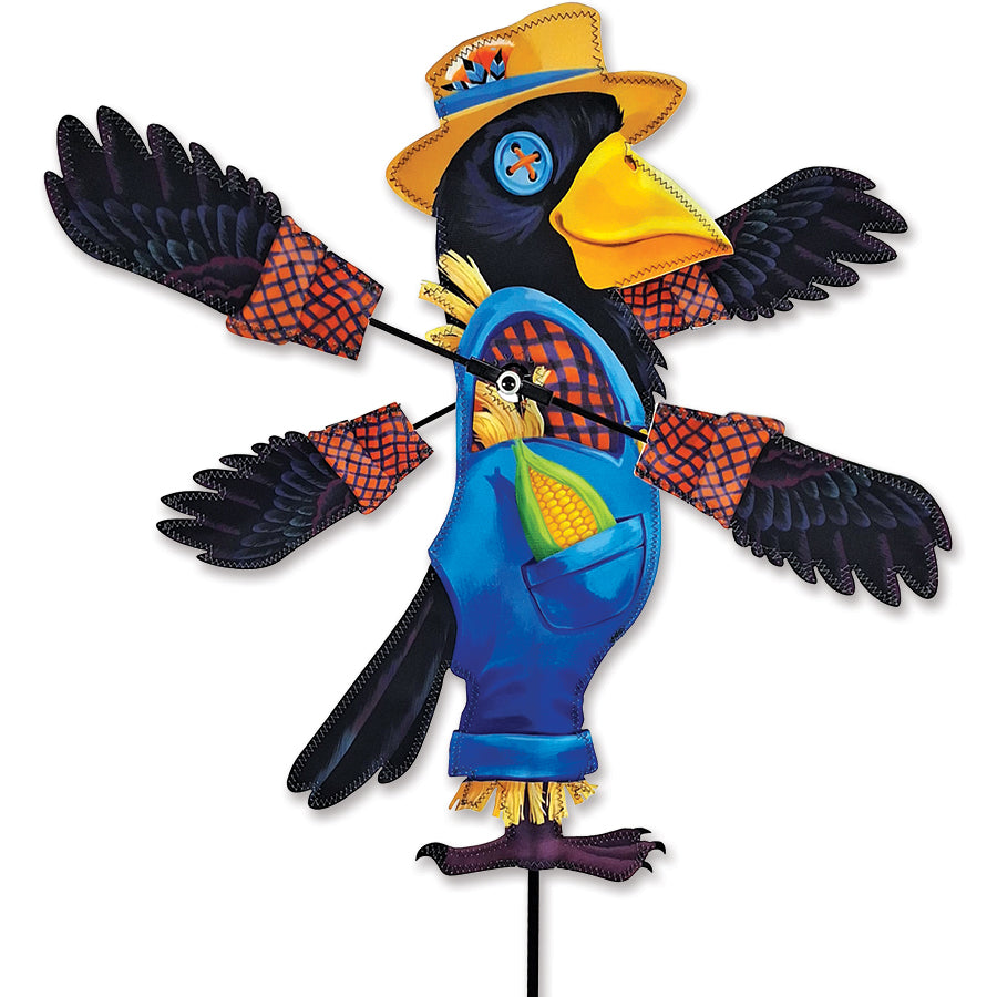 WhirliGig Spinner - Crow Scarecrow in a garden setting with colorful SunTex fabric wings spinning in the wind.