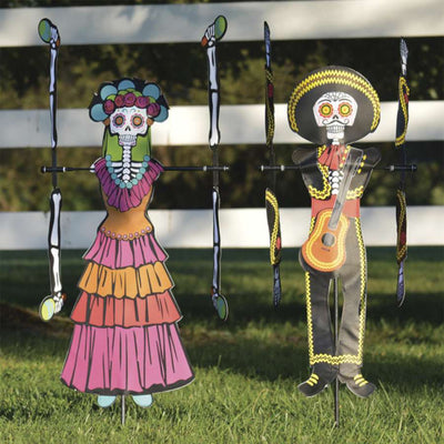 WhirliGig Spinner - Day of the Dead Woman spinning in a garden, showcasing vibrant colors and intricate patterns against the backdrop of outdoor greenery.