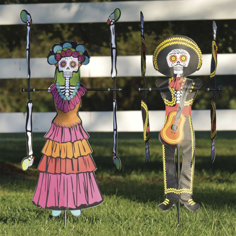 WhirliGig Spinner - Day of the Dead Woman spinning in a garden, showcasing vibrant colors and intricate patterns against the backdrop of outdoor greenery.