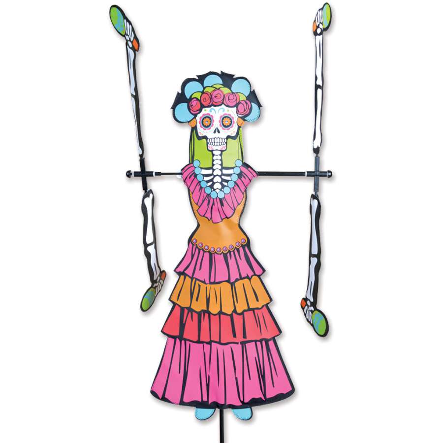 WhirliGig Spinner - Day of the Dead Woman spinning in a garden, showcasing vibrant colors and intricate patterns against the backdrop of outdoor greenery.