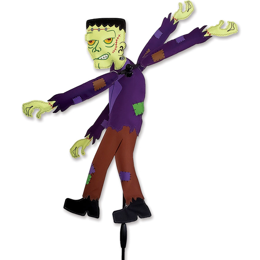 WhirliGig Spinner - Frankenstein showcasing a colorful design, spinning gently in a garden setting, perfect for outdoor decor.