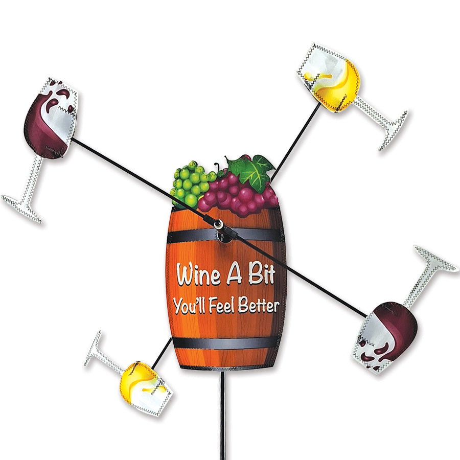 WhirliGig Spinner - Wine A Bit, a 21-inch colorful garden decoration with vibrant fabric spinning gracefully in the breeze in an outdoor setting.