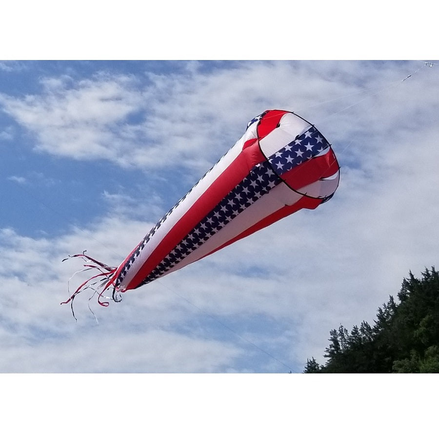 Wind Turbine 500 in vibrant colors spinning gracefully outdoors, showcasing its patriotic design against a clear blue sky.