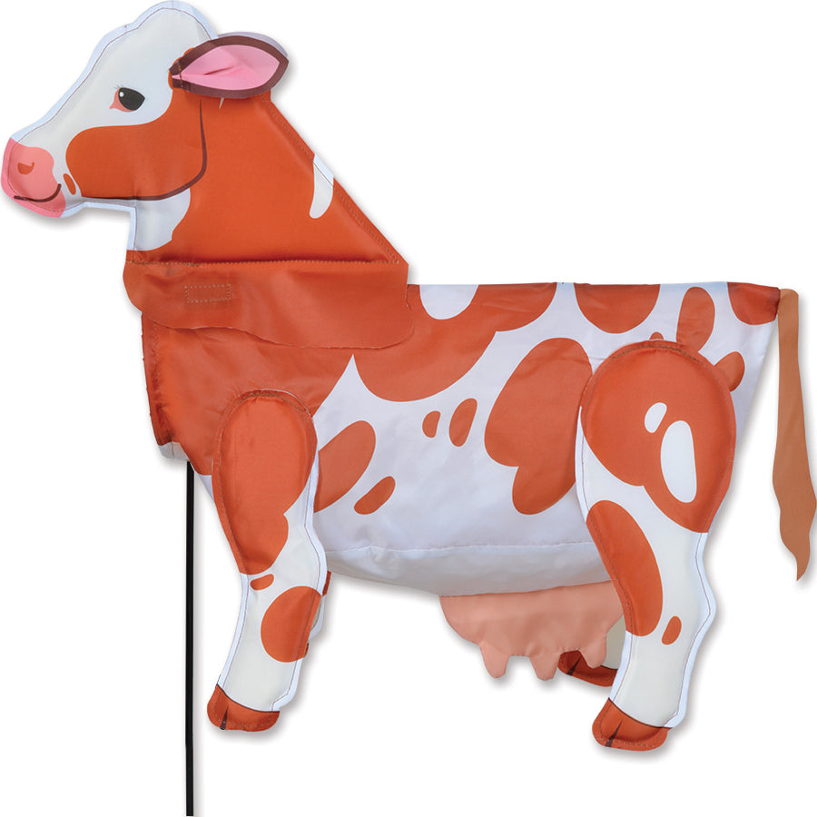 Windicator - Brown Cow weather vane dancing in the wind, showcasing a lively inflatable brown cow design in a sunny outdoor setting.
