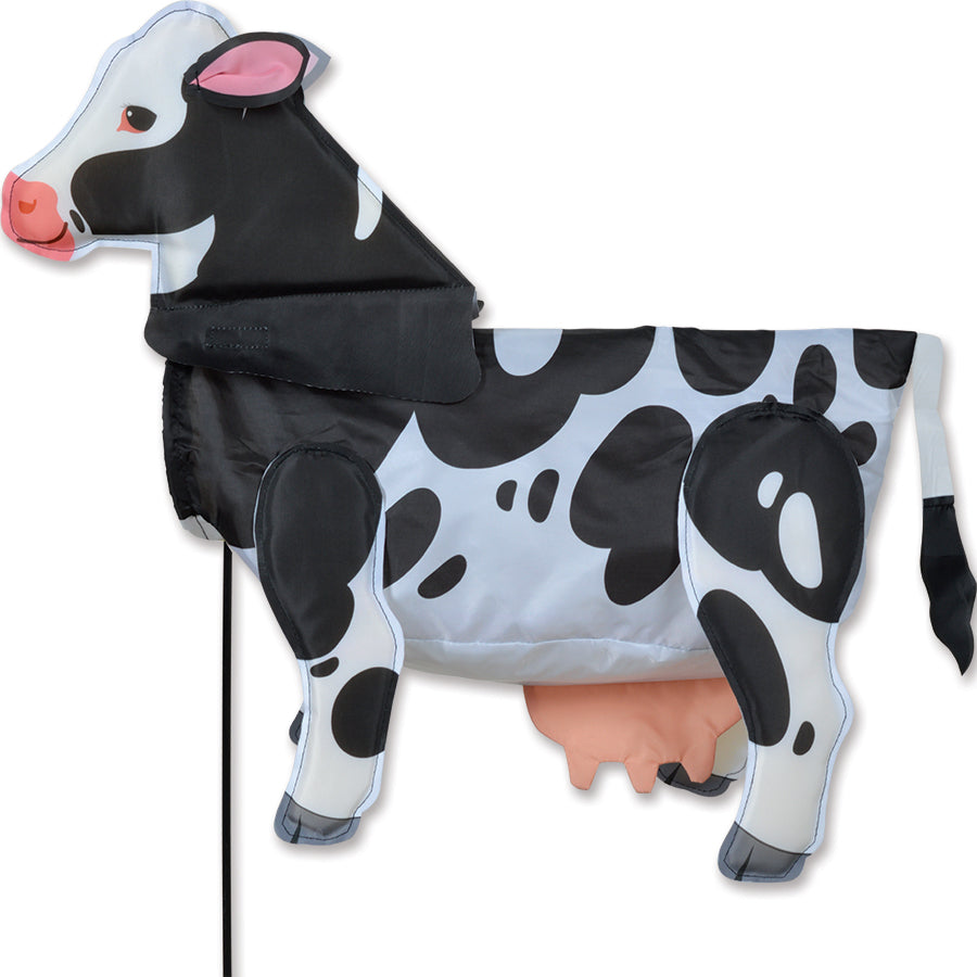 Windicator - Cow weather vane in a garden setting, showcasing a lively cow character that inflates in the wind, perfect for outdoor decoration.