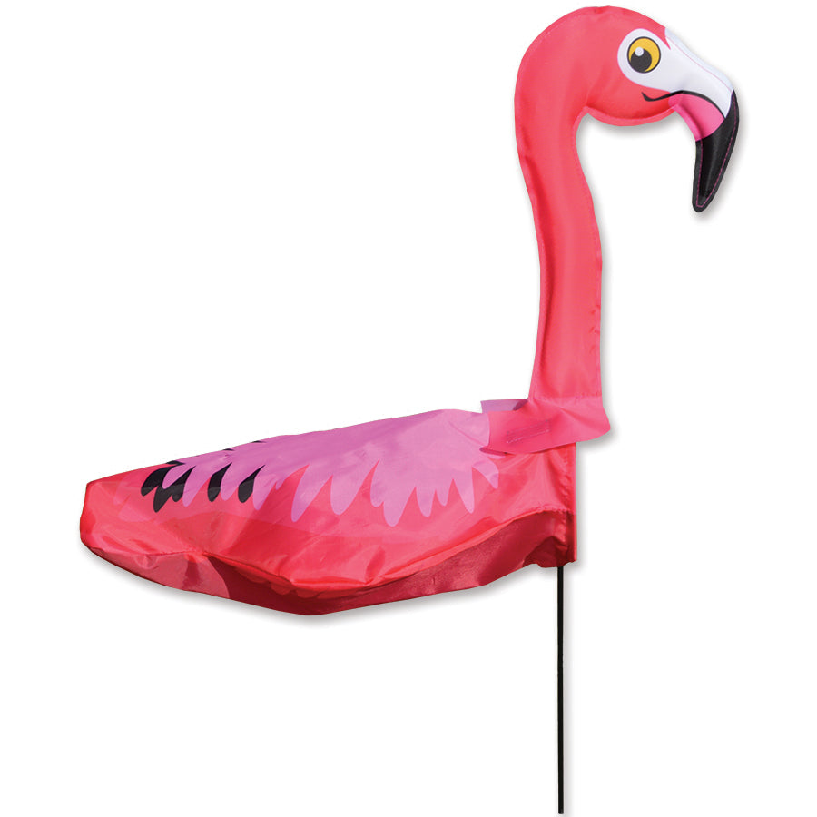 Windicator - Flamingo whimsical weather vane in a garden, showcasing a bright 3-D flamingo design dancing in the breeze on a fiberglass pole.