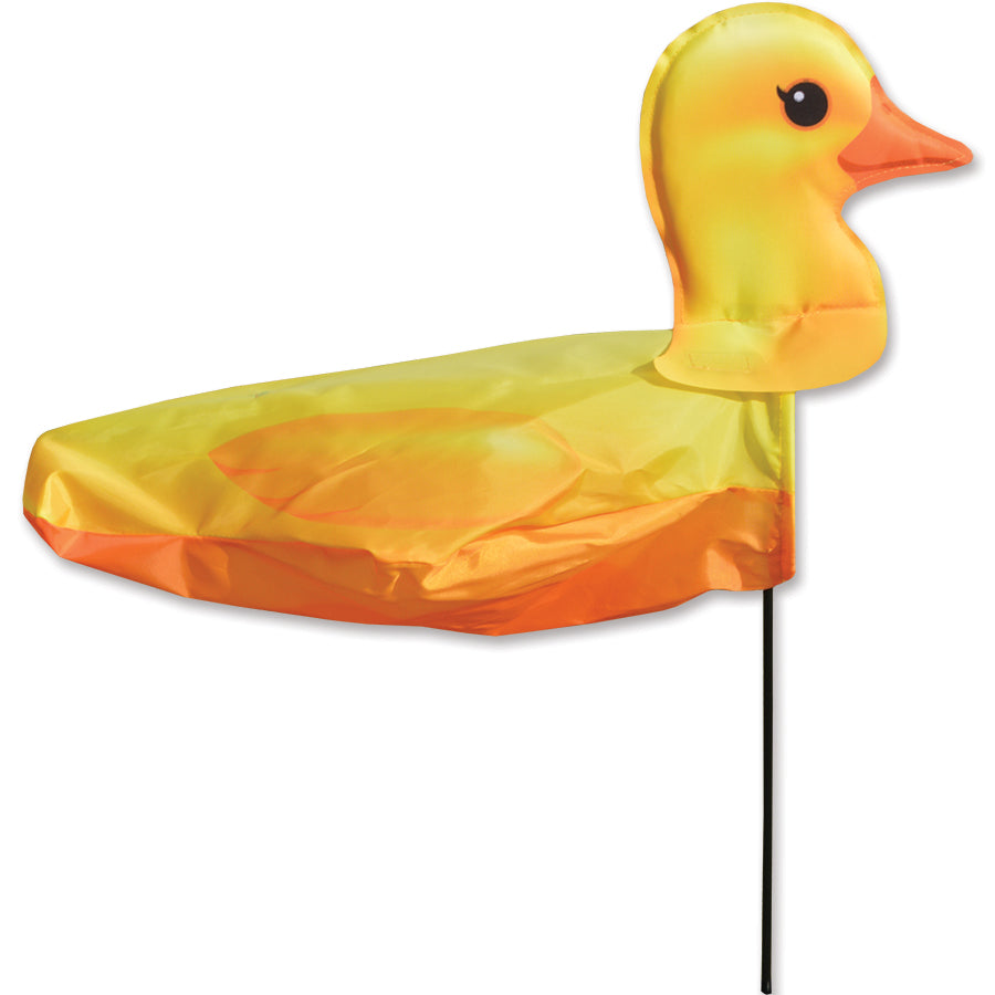 Windicator - Rubber Ducky weather vane in a garden setting, dancing in the wind with bright colors and cheerful design.