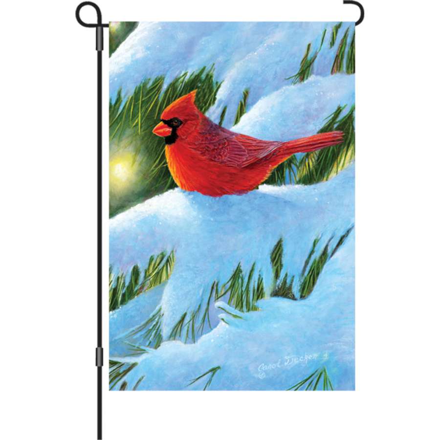 12 in. Winter Glow Cardinal garden flag illuminated against winter scenery, showcasing a vibrant cardinal on a snowy backdrop.