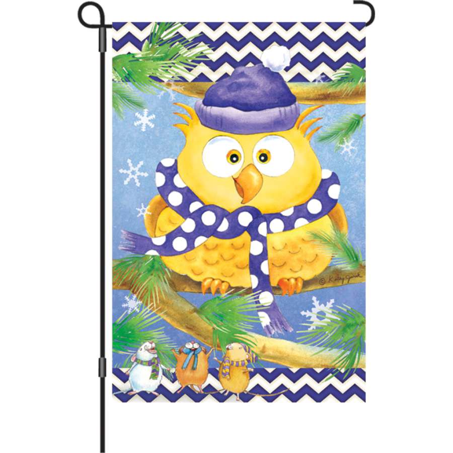 12 in. Winter Owl Flag featuring an illuminated design of a majestic owl perched in a snowy landscape on a garden display.
