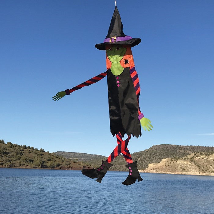 Witch 40-inch Breeze Buddy windsock with flowing arms and legs displayed outdoors, capturing the spirit of Halloween excitement.