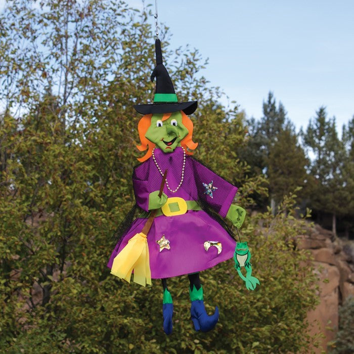 Witch Wind Friend 3D windsock design featuring a witch and frog, hanging outdoors in a colorful garden setting, perfect for Halloween.