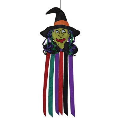 Witch Windtail Halloween decoration featuring a green witch with flowing hair and fluttering colorful tails hung outdoors, showcasing its festive design.