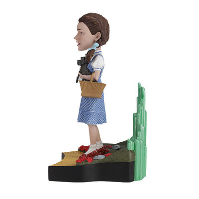 The Wizard Of Oz - Dorothy Gale Bobblehead showcases Dorothy in her classic outfit with RUBY SLIPPERSTM, capturing the essence of the beloved film character.