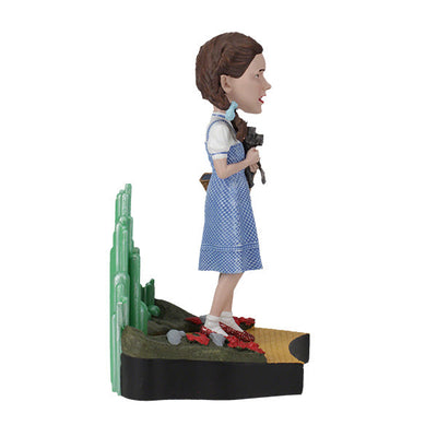 The Wizard Of Oz - Dorothy Gale Bobblehead showcases Dorothy in her classic outfit with RUBY SLIPPERSTM, capturing the essence of the beloved film character.
