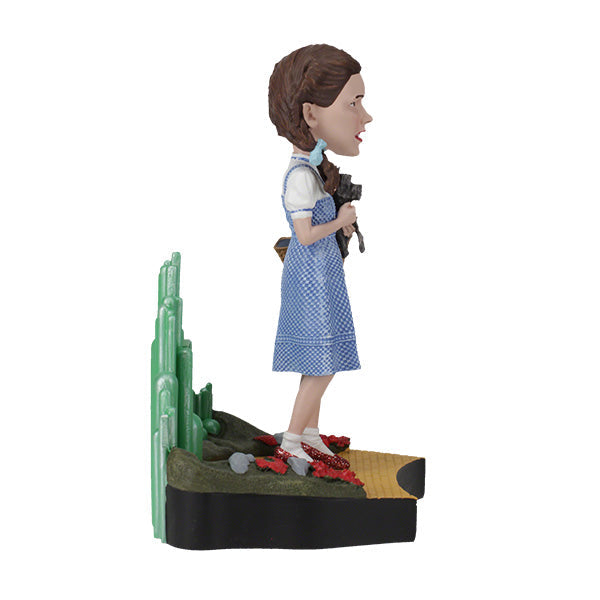The Wizard Of Oz - Dorothy Gale Bobblehead showcases Dorothy in her classic outfit with RUBY SLIPPERSTM, capturing the essence of the beloved film character.