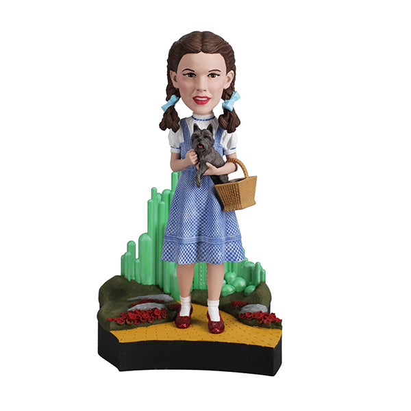 The Wizard Of Oz - Dorothy Gale Bobblehead showcases Dorothy in her classic outfit with RUBY SLIPPERSTM, capturing the essence of the beloved film character.