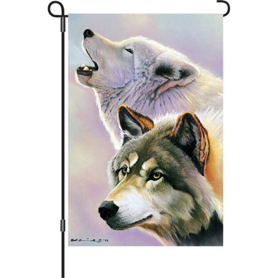 Wolves Are Forever illuminated garden flag featuring lifelike wolf imagery displayed outdoors, glowing softly in the evening light.