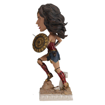 DC: Wonder Woman bobblehead featuring Gal Gadot's likeness, crafted from durable polyresin, showcased on a desk against a neutral backdrop.