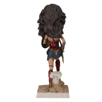 DC: Wonder Woman bobblehead featuring Gal Gadot's likeness, crafted from durable polyresin, showcased on a desk against a neutral backdrop.