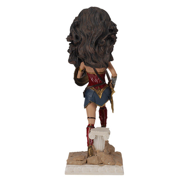 DC: Wonder Woman bobblehead featuring Gal Gadot's likeness, crafted from durable polyresin, showcased on a desk against a neutral backdrop.