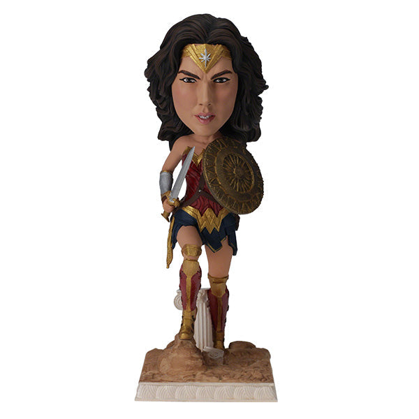 DC: Wonder Woman bobblehead featuring Gal Gadot's likeness, crafted from durable polyresin, showcased on a desk against a neutral backdrop.