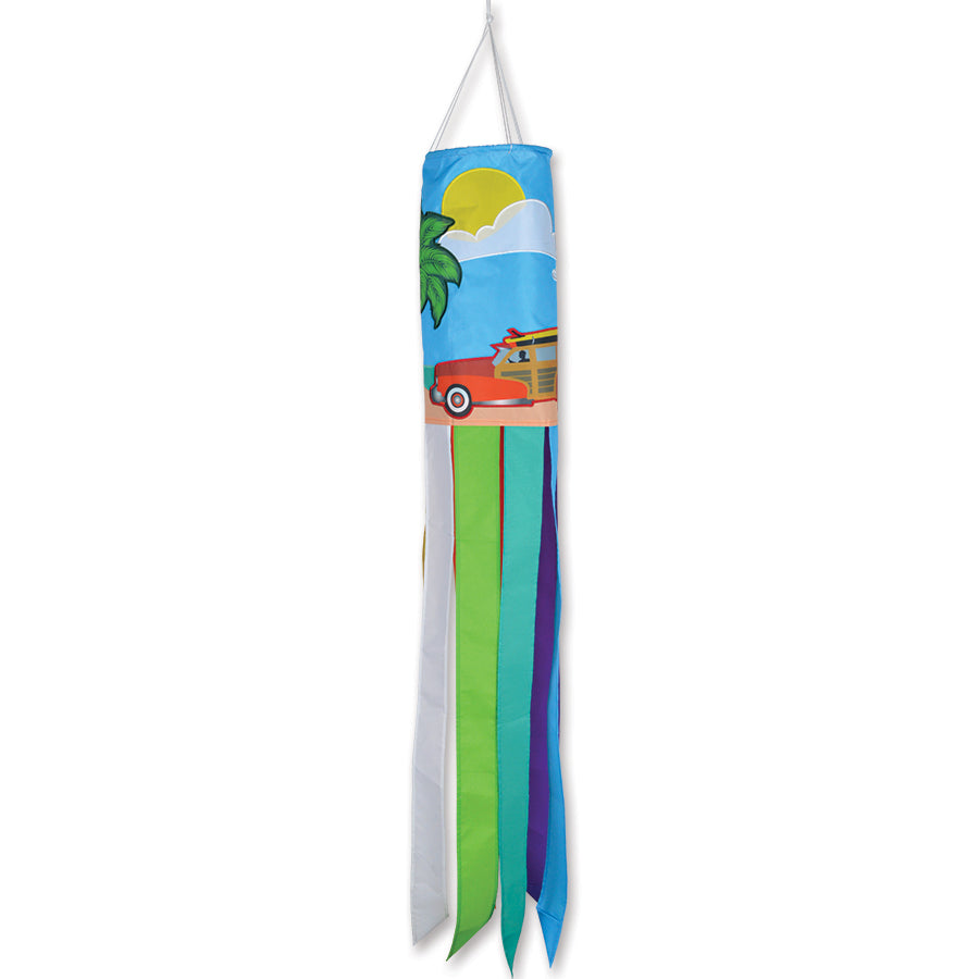 Woodies windsock featuring vibrant embroidered applique designs, displayed outdoors in a garden setting, fluttering in the wind.