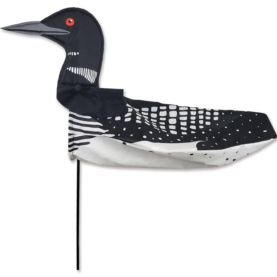 XL Windicator Weather Vane featuring a playful loon design, swaying in the wind mounted on a sturdy pole in a garden setting.