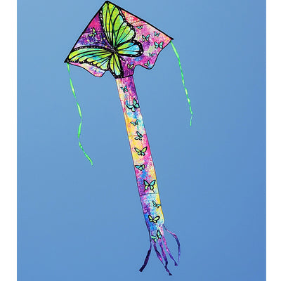Zephyr Kite - Green Butterfly soaring in a blue sky, showcasing its vibrant wingspan of 64x165 inches with a backdrop of open fields.