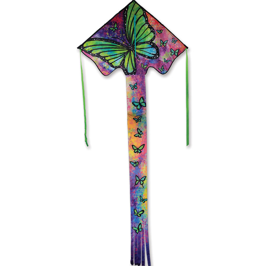 Zephyr Kite - Green Butterfly soaring in a blue sky, showcasing its vibrant wingspan of 64x165 inches with a backdrop of open fields.